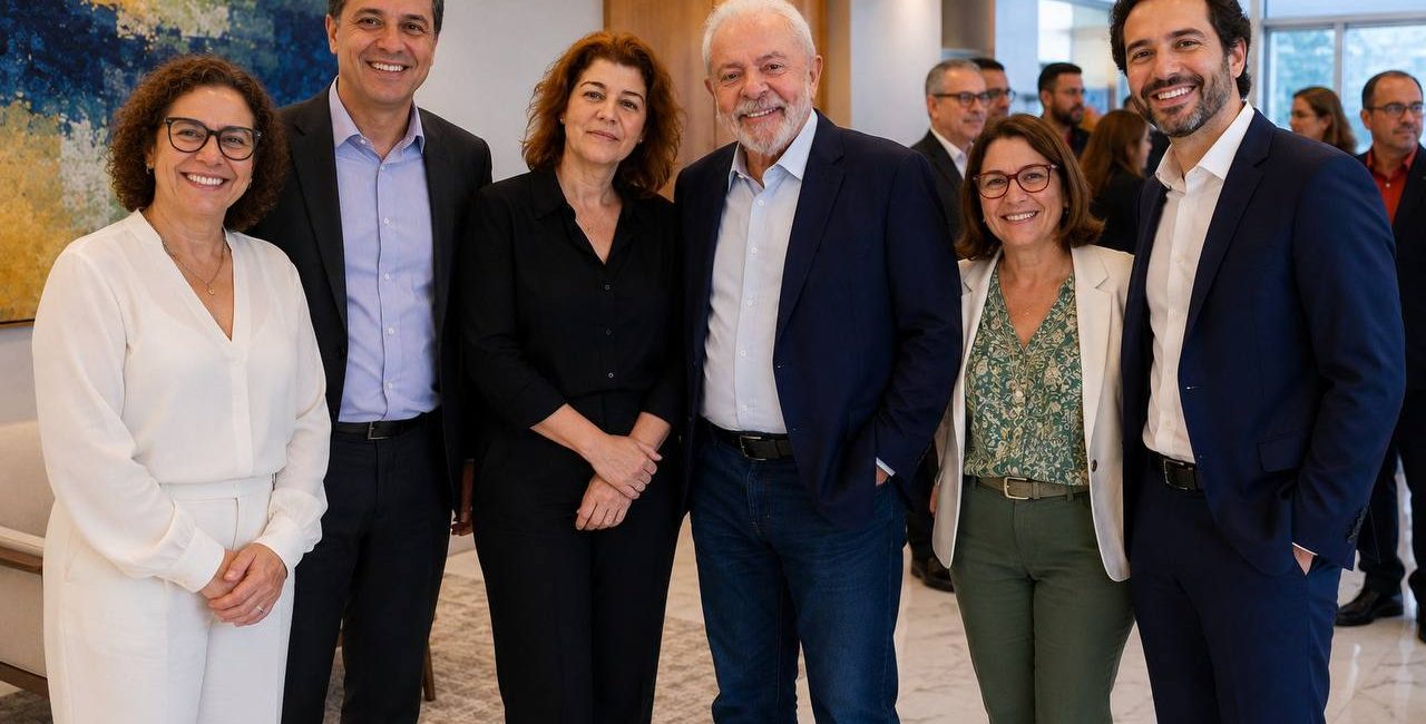 Six smiling professionals stand together in a modern lobby for a group photo at a business event, with abstract art in the background.