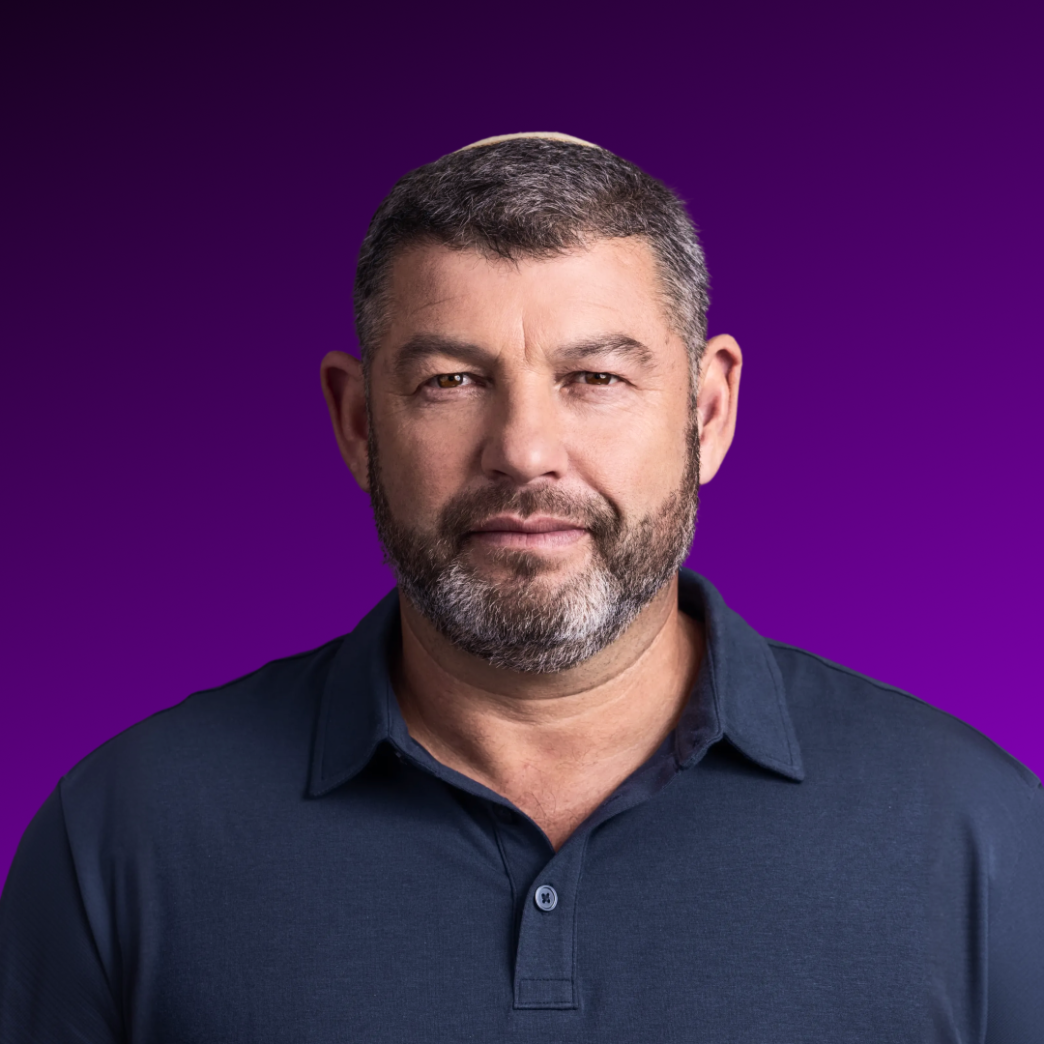 Portrait of Ofer Winter against a purple background