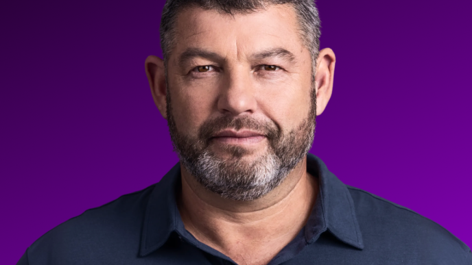Portrait of Ofer Winter against a purple background