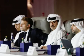 Qatar Emir Sheikh Tamim bin Hamad Al Thani and French President Macron seated at a meeting table