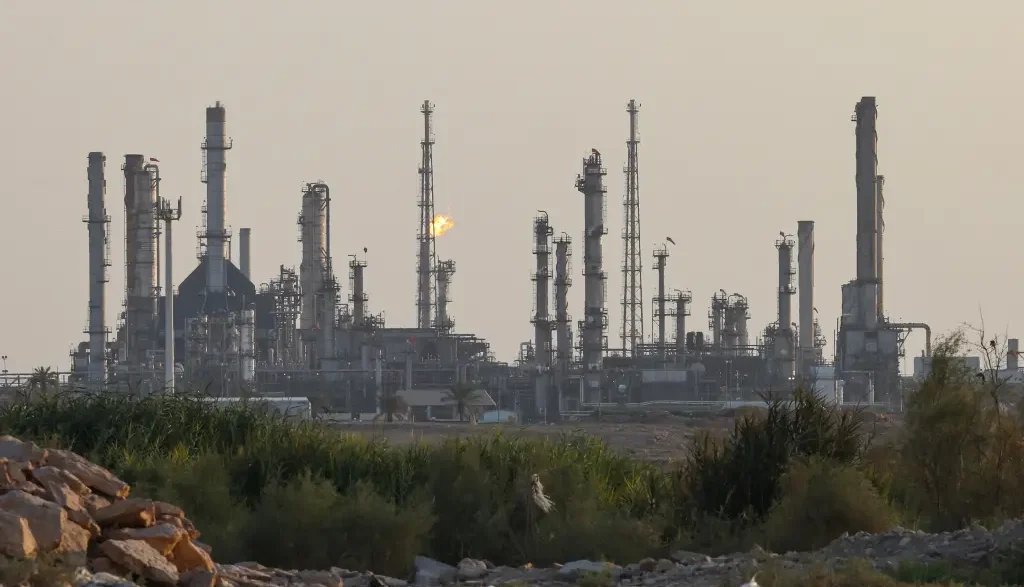 Saudi oil refinery with flare stacks at dusk