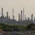 Saudi oil refinery with flare stacks at dusk